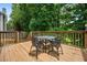 Outdoor deck area with wrought iron table and chair set at 507 Mirramont Pl, Woodstock, GA 30189