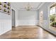 Dining room with a coffered ceiling, hardwood floors, windows, gray walls, and white trim at 507 Mirramont Pl, Woodstock, GA 30189