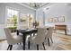 Dining room with a coffered ceiling, hardwood floors, gray walls, white trim, and a serving table at 507 Mirramont Pl, Woodstock, GA 30189