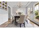 Dining room with a coffered ceiling, hardwood floors, windows, gray walls, and white trim at 507 Mirramont Pl, Woodstock, GA 30189