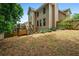 Back view of a two-story home featuring a wood deck, a fenced yard, and landscaping at 507 Mirramont Pl, Woodstock, GA 30189