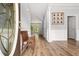 Bright foyer with hardwood floors, neutral paint, white trim, and a traditional wooden bench at 507 Mirramont Pl, Woodstock, GA 30189