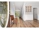 Bright foyer with light gray walls, wood floors, decorative molding, and a wooden bench at 507 Mirramont Pl, Woodstock, GA 30189