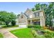 Charming two-story home with a well-manicured lawn, attached garage, and a welcoming front porch at 507 Mirramont Pl, Woodstock, GA 30189