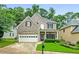 Charming two-story home with a well-maintained lawn, two car garage, and mature trees at 507 Mirramont Pl, Woodstock, GA 30189