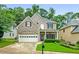 Charming two-story home featuring a brick facade, a two-car garage, and a well-maintained front yard at 507 Mirramont Pl, Woodstock, GA 30189