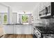 Modern kitchen with stainless steel appliances, granite countertops, and view to deck at 507 Mirramont Pl, Woodstock, GA 30189