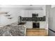 Well-appointed kitchen with granite counters, stainless steel appliances, and dark backsplash at 507 Mirramont Pl, Woodstock, GA 30189