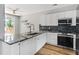Bright kitchen featuring white cabinets, granite countertops, and stainless steel appliances at 507 Mirramont Pl, Woodstock, GA 30189