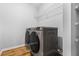Bright laundry room featuring new machines and wood-look flooring at 507 Mirramont Pl, Woodstock, GA 30189