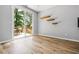 Bright living area has a sliding glass door to a deck, wood floors, and natural light at 507 Mirramont Pl, Woodstock, GA 30189