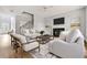 Bright living room features a fireplace, wood floors, staircase, and comfortable seating at 507 Mirramont Pl, Woodstock, GA 30189