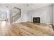 An open-concept living area features a fireplace, wood floors, and natural light at 507 Mirramont Pl, Woodstock, GA 30189