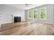 Spacious living room featuring a fireplace, hardwood floors, three windows, and gray walls at 507 Mirramont Pl, Woodstock, GA 30189