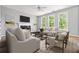 Bright living room with hardwood floors, neutral paint, white trim, and lots of natural light at 507 Mirramont Pl, Woodstock, GA 30189