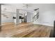 The bright living room is adjacent to the kitchen, and it has wood floors and stairs at 507 Mirramont Pl, Woodstock, GA 30189
