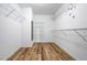 Spacious walk-in closet with wooden floors and wire shelving for optimal storage and organization at 507 Mirramont Pl, Woodstock, GA 30189