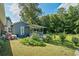 Exterior shot of home with spacious backyard featuring a covered porch and storage at 680 Harbor Point Ct, Lawrenceville, GA 30044