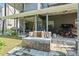 View of the backyard with outdoor brick fireplace and covered porch at 680 Harbor Point Ct, Lawrenceville, GA 30044