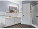 Bright bathroom with double sinks, white cabinets, and a shower with glass door at 680 Harbor Point Ct, Lawrenceville, GA 30044