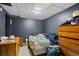 A cluttered room with dark grey walls, and limited natural light. Includes dressers and bed at 680 Harbor Point Ct, Lawrenceville, GA 30044