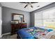 Bedroom with hardwood floors, dresser, and natural light coming from the window at 680 Harbor Point Ct, Lawrenceville, GA 30044