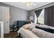 Bedroom featuring a window, dark accents, and wood-look floors at 680 Harbor Point Ct, Lawrenceville, GA 30044