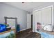 Bedroom with laminate floors and a double-door closet at 680 Harbor Point Ct, Lawrenceville, GA 30044