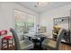 Bright breakfast nook with a glass table and views of the backyard at 680 Harbor Point Ct, Lawrenceville, GA 30044