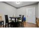 Small dining area with a black table and chairs with a view of the rear exit door at 680 Harbor Point Ct, Lawrenceville, GA 30044