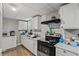 Kitchen equipped with white cabinets and black appliances at 680 Harbor Point Ct, Lawrenceville, GA 30044