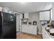 Kitchen with black refrigerator and white cabinetry offering ample storage space at 680 Harbor Point Ct, Lawrenceville, GA 30044