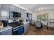 Modern kitchen with stainless steel appliances, granite countertops, and a cozy breakfast nook area for casual dining at 680 Harbor Point Ct, Lawrenceville, GA 30044