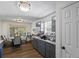 A kitchen featuring gray cabinets, granite countertops, and a cozy dining area with natural light streaming through the window at 680 Harbor Point Ct, Lawrenceville, GA 30044