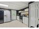 A spacious basement kitchen with white appliances and tiled floors, great for guests at 680 Harbor Point Ct, Lawrenceville, GA 30044