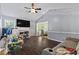 Cozy living room featuring hardwood floors, gray walls, a vaulted ceiling, and a ceiling fan for added comfort at 680 Harbor Point Ct, Lawrenceville, GA 30044
