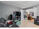 A view of the living room with light wood floors, grey walls, and dark furniture at 680 Harbor Point Ct, Lawrenceville, GA 30044