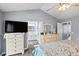 Spacious main bedroom featuring a ceiling fan, ensuite bathroom, and dressers for storage at 680 Harbor Point Ct, Lawrenceville, GA 30044