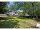 A large backyard features green grass, a privacy fence, and mature trees at 2130 Main Nw St, Atlanta, GA 30318