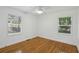 This light-filled bedroom features gleaming hardwood floors, white walls, and two windows at 2130 Main Nw St, Atlanta, GA 30318