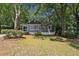 Charming single-story home featuring a screened front porch and lush, mature landscaping at 2130 Main Nw St, Atlanta, GA 30318