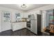 Well-lit kitchen features stainless steel appliances, white cabinets, and dark hexagon tile floor at 2130 Main Nw St, Atlanta, GA 30318