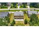 Aerial view of home's backyard with patio, surrounded by lush greenery, in a serene, suburban neighborhood at 2445 Whitehead Place Dr, Suwanee, GA 30024