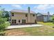 Back of home featuring a large concrete patio surrounded by a well manicured yard at 2445 Whitehead Place Dr, Suwanee, GA 30024