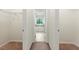 Hallway view of a bathtub in a bathroom, featuring neutral colors and natural light at 2445 Whitehead Place Dr, Suwanee, GA 30024