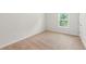 A simple, light-filled bedroom with neutral walls and carpet at 2445 Whitehead Place Dr, Suwanee, GA 30024
