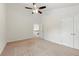 Spacious room with carpet floors and a ceiling fan, offering a blank canvas for personalization and comfort at 2445 Whitehead Place Dr, Suwanee, GA 30024