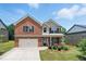 Charming two-story brick home with a well-maintained lawn and attached two-car garage with concrete driveway at 2445 Whitehead Place Dr, Suwanee, GA 30024