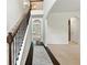 Bright foyer featuring hardwood floors, staircase with iron railing, arched doorways, and neutral color palette at 2445 Whitehead Place Dr, Suwanee, GA 30024