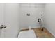 The laundry room offers ceramic tile flooring, washer/dryer hookups, and a wire rack at 2445 Whitehead Place Dr, Suwanee, GA 30024